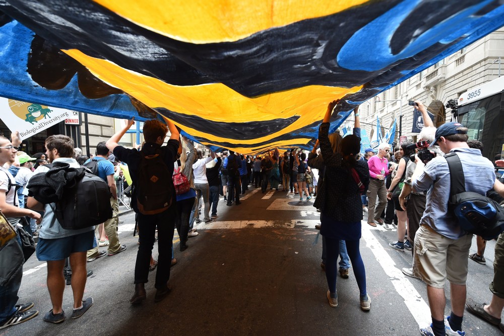 Protestors make their way up Broadway as they take part in the "Flood Wall Street" demonstrations on Sept. 22, 2014, preceding the United Nations's "Climate Summit 2014: Catalyzing Action" in New York, N.Y. (Photo by Timothy A. Clary/AFP/Getty)