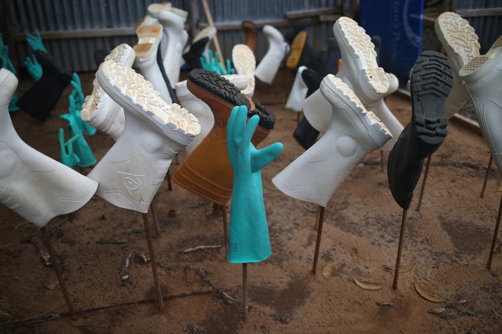 Sanitized gloves and boots hang to dry as a burial team collects Ebola victims from a Ministry of Health treatment center for cremation on October 2, 2014 in Monrovia, Liberia.