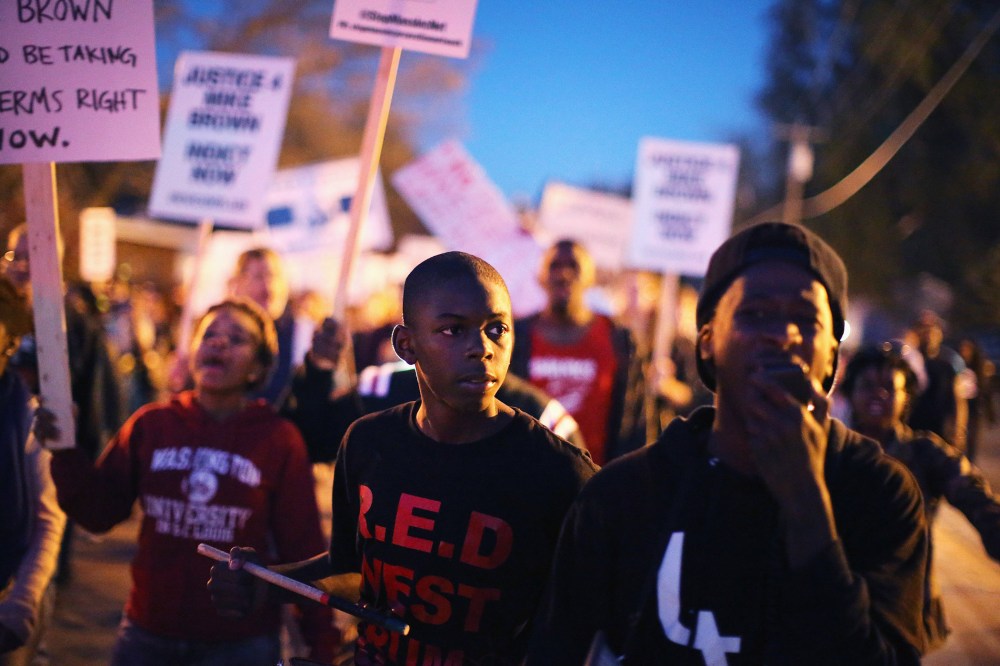 Demonstrators march toward the police station as protests continue in the wake of 18-year-old Michael Brown's death on Oct. 22, 2014 in Ferguson, Mo.