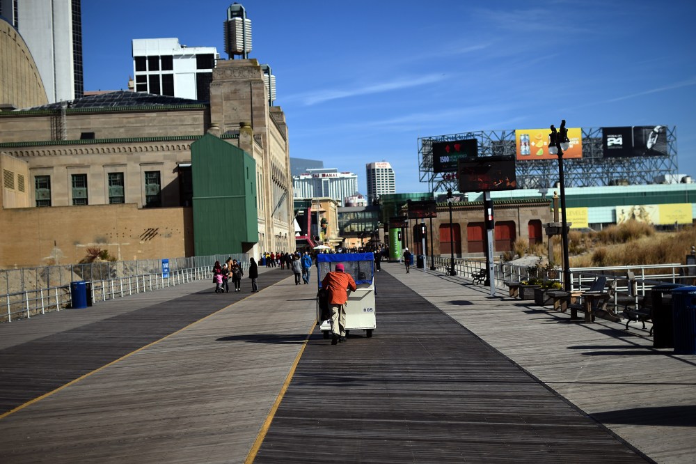 A man moves passengers on a "push cab" along the boardwalk in Atlantic City, N.J., on Nov. 8, 2014. (Photo by Jewel Samad/AFP/Getty)