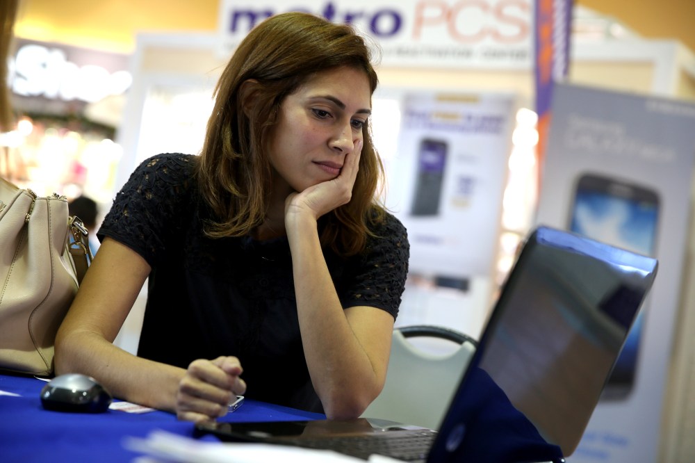 Maritza Martinez works with an insurance agent to purchase health insurance under the Affordable Care Act on Dec. 22, 2013 in Miami, Fla.