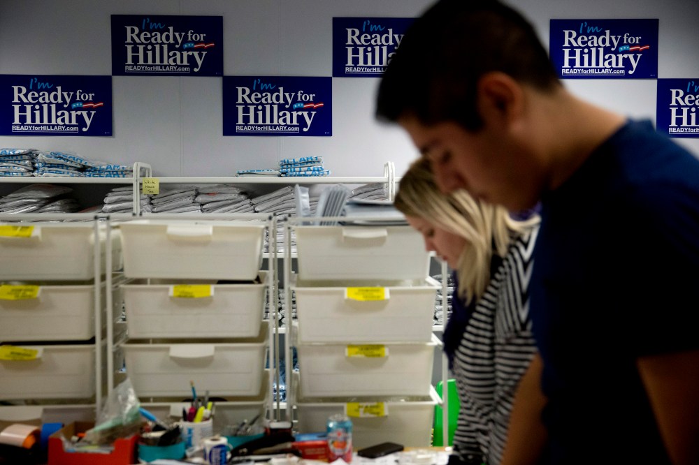 "I'm Ready for Hillary" posters hang on the wall as interns fulfill customer's orders at the Ready For Hillary PAC headquarters store in Arlington, Virginia, on Nov. 12, 2014. (Photo by Andrew Harrer/Bloomberg via Getty)