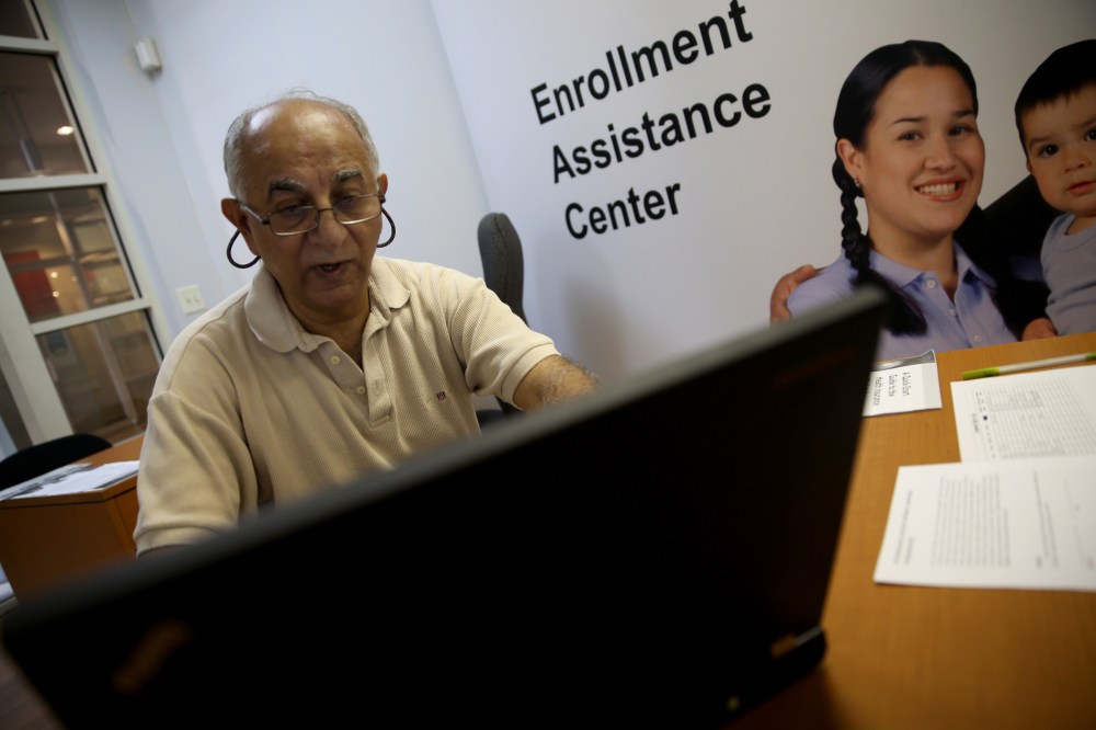 Narendra Parmar finishes the process of picking and signing up for health insurance through the Affordable Care act at a Miami Enrollment Assistance Center on December 23, 2013 in Miami, Florida.