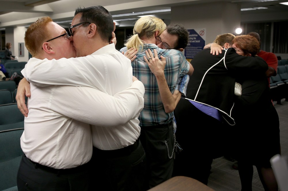 Newlyweds embrace after getting married during a ceremony at the Broward County Courthouse on Jan. 6, 2015 in Fort Lauderdale, Fla. (Photo by Joe Raedle/Getty)
