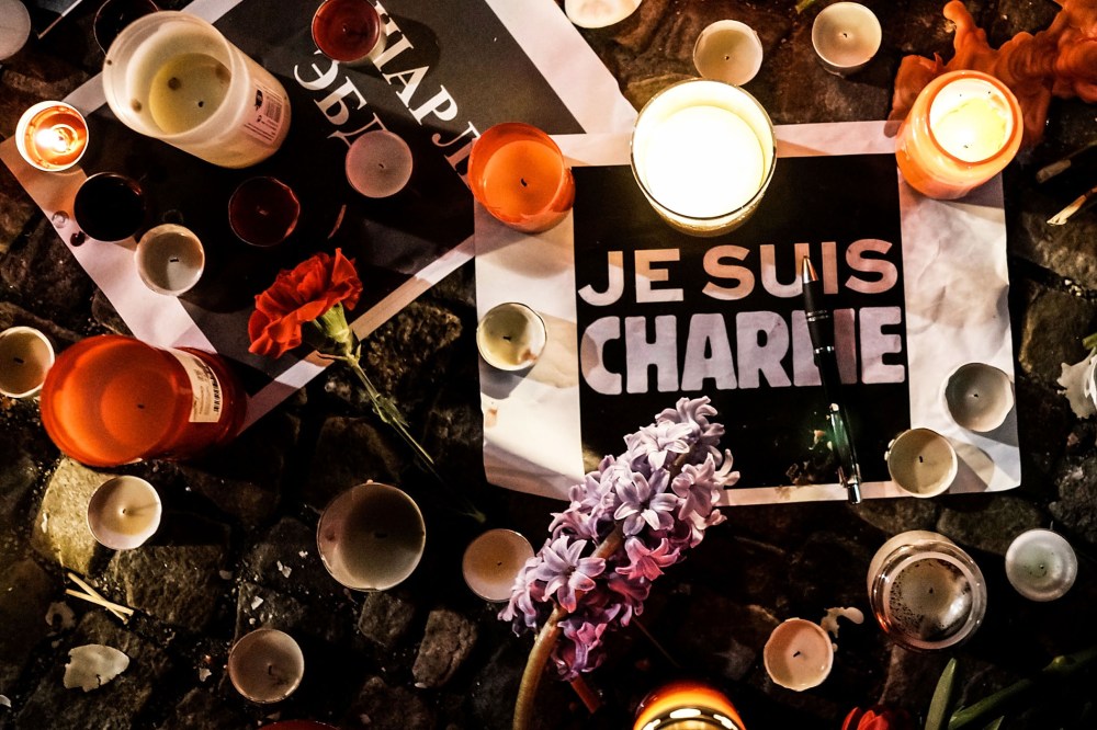 Papers with 'I am Charlie' displayed are left near candles at a vigil in front of the French Embassy following the terrorist attack in Paris on January 7, 2015 in Berlin, Germany. (Photo by Carsten Koall/Getty)