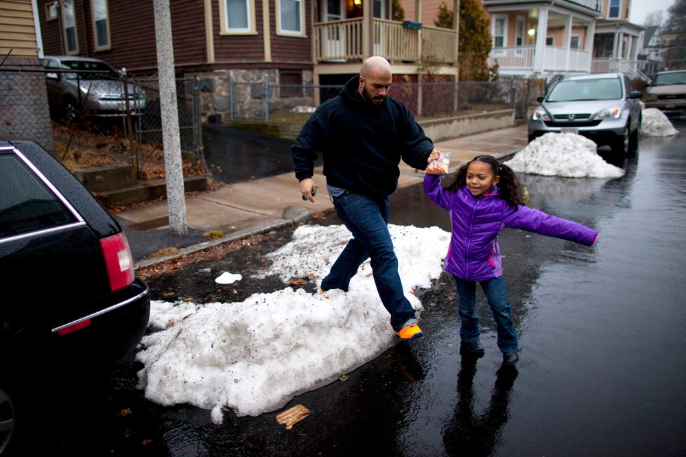 Yasmani Santiago, 32, of Dorchester, walks his daughter to the car, Dec. 23, 2013. Santiago is one of the tens of thousands of Massachusetts residents who prepared to lose their unemployment benefits on Dec. 28th.