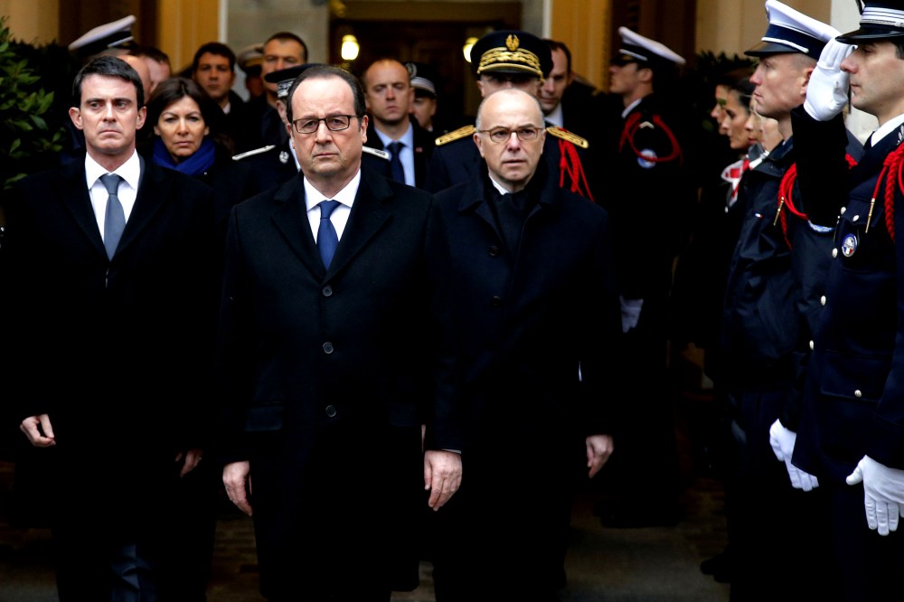 French President Francois Hollande (C), Prime Minister Manuel Valls (L) and Interior Minister Bernard Cazeneuve (R) pay tribute to the three police officers killed in the islamist attacks on Jan. 13, 2015 in Paris. (Photo by Francois Mori/AFP/Getty)