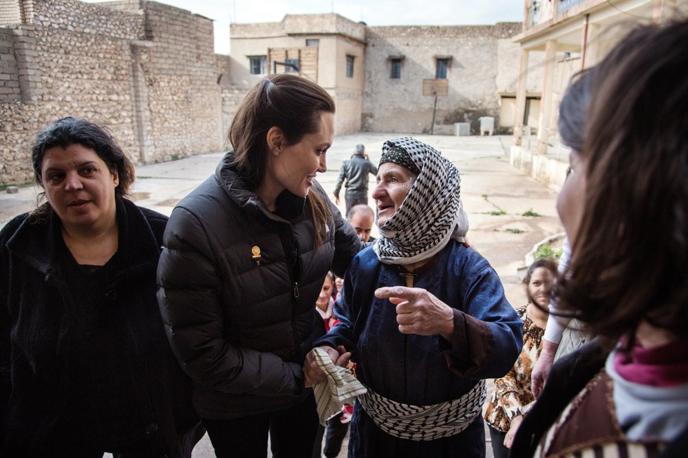 Angelina Jolie meets meets displaced Iraqis who are members of the minority Christian community, living in an abandoned school, on Jan. 26, 2015 in Al Qosh, Iraq. (Photo by Andrew McConnell/UNHCR/Getty)