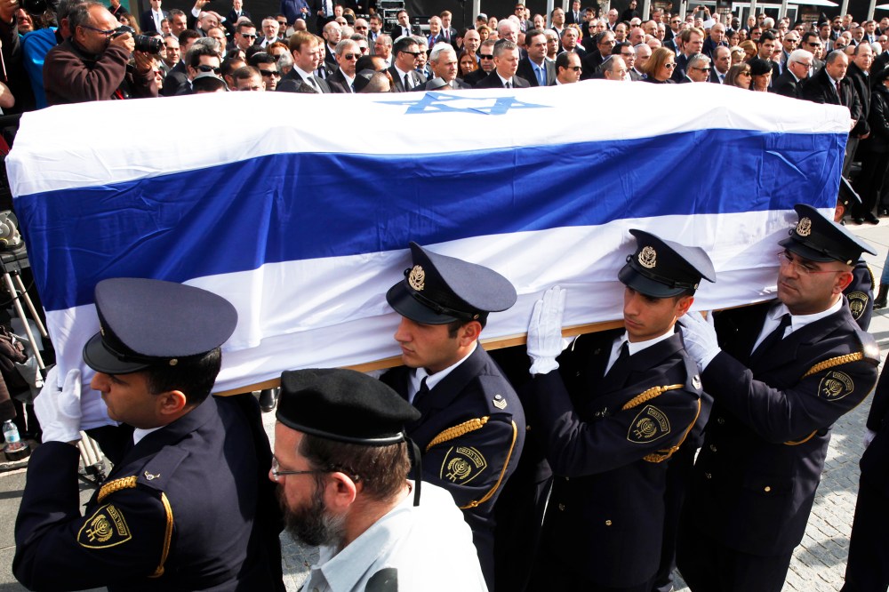 An honor guard carries the coffin of former Israeli prime minister Ariel Sharon, Jan. 13, 2014.