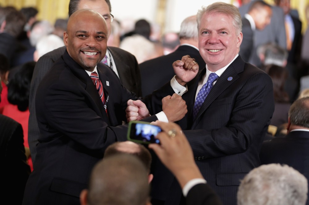 Denver Mayor Michael Hancock (L) and Seattle Mayor Ed Murray posing for photographs during a reception in the East Room of the White House Jan. 23, 2014 in Washington, DC.
