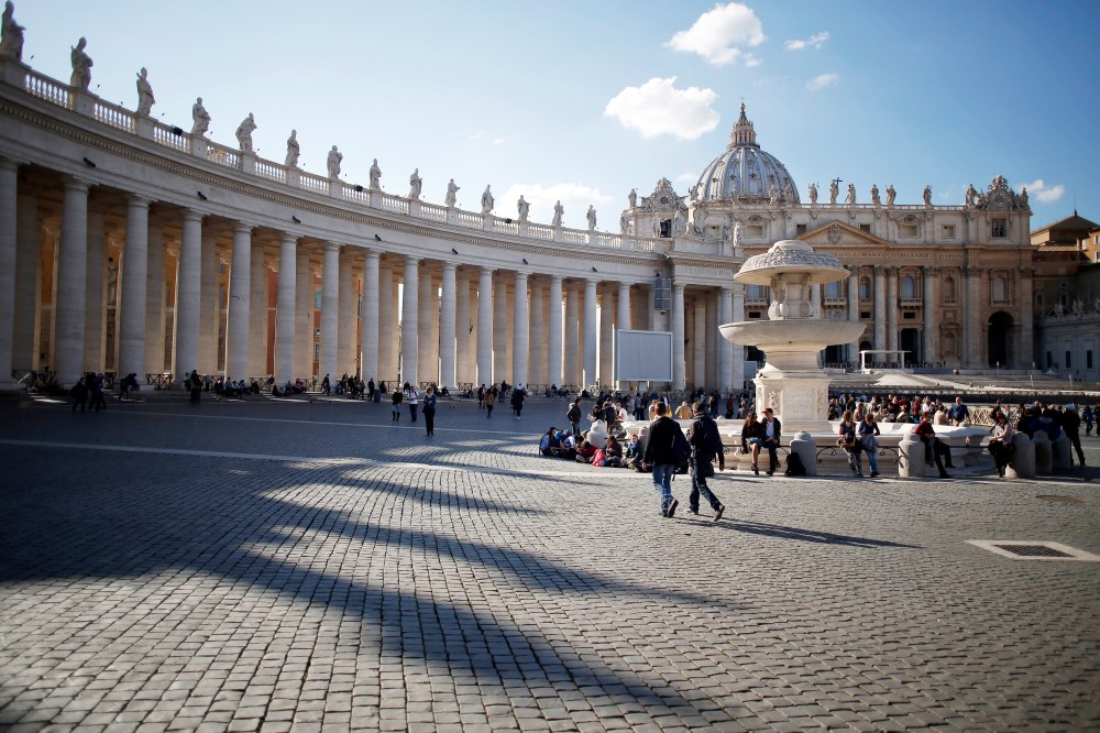 Visitors and tourists walk near the Basilica in St Peter's Square in Vatican City on Feb. 17, 2015. (Photo by Alessia Pierdomenico/Bloomberg/Getty)