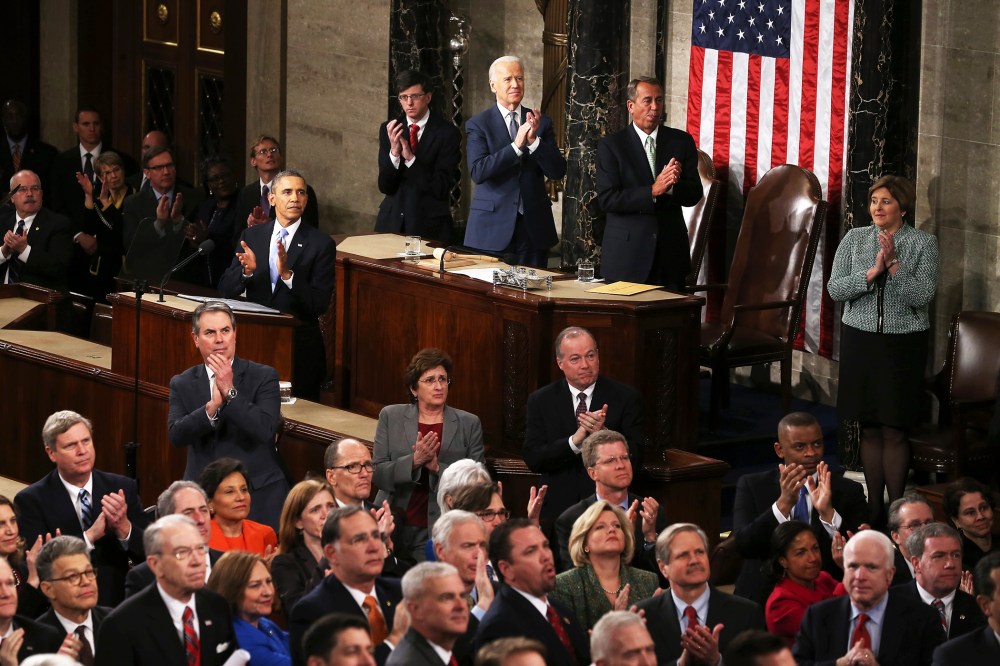 U.S. President Barack Obama and others applaud during the State of the Union, Jan. 28, 2014.