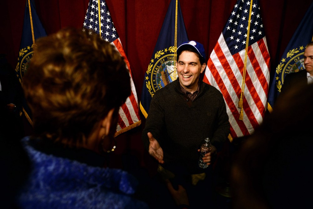 Wisconsin Governor Scott Walker shakes hands with people following a grassroots training and rally event at Concord High School March 14, 2015 in Concord, N.H. (Photo by Darren McCollester/Getty)