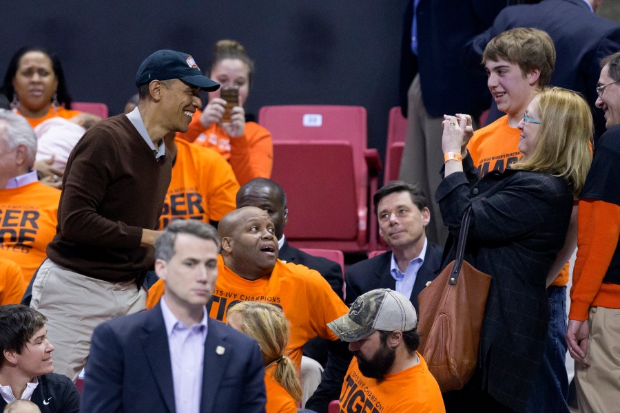 President Barack Obama poses for a photo while attending the Green Bay vs. Princeton women's college basketball game in the first round of the NCAA tournament, March 21, 2015. (Photo by MIchael Reynolds-Pool/Getty)