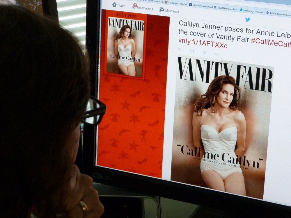 A journalist looks at Vanity Fair's Twitter site with the Tweet about Caitlyn Jenner, who will be featured on the July cover of the magazine. (Photo by Mladen Antonov/AFP/Getty)