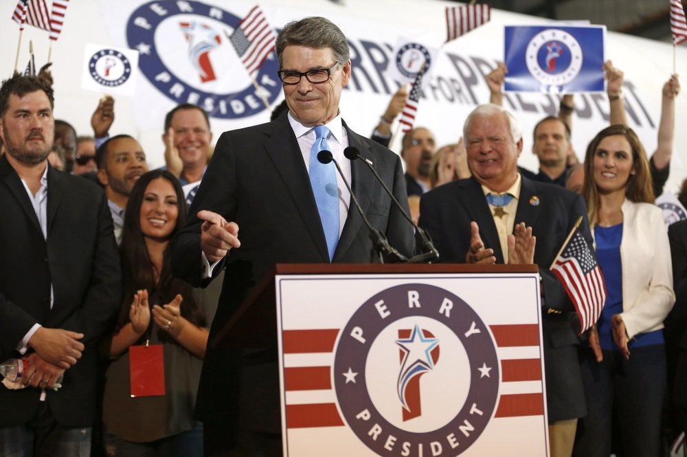 Former Texas Governor Rick Perry points to a supporter after announcing that he will run for president in 2016 June 4, 2015 in Dallas, Texas. (Photo by Ron Jenkins/Getty)