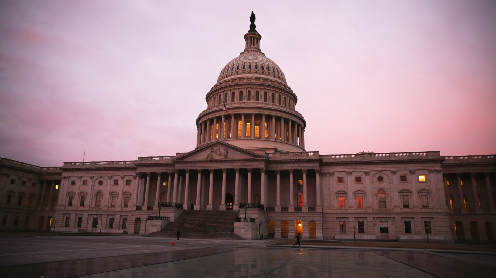 The morning sun begins to rise in front of the U.S. Capitol. (Photo by Mark Wilson/Getty)