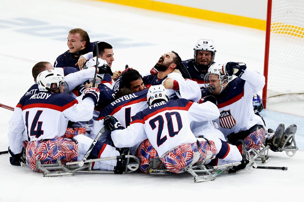 Team USA celebrates winning the Ice Sledge Hockey Gold Medal match between Russia and USA at the Shayba Arena during day eight of the 2014 Paralympic Winter Games on March 15, 2014 in Sochi, Russia.