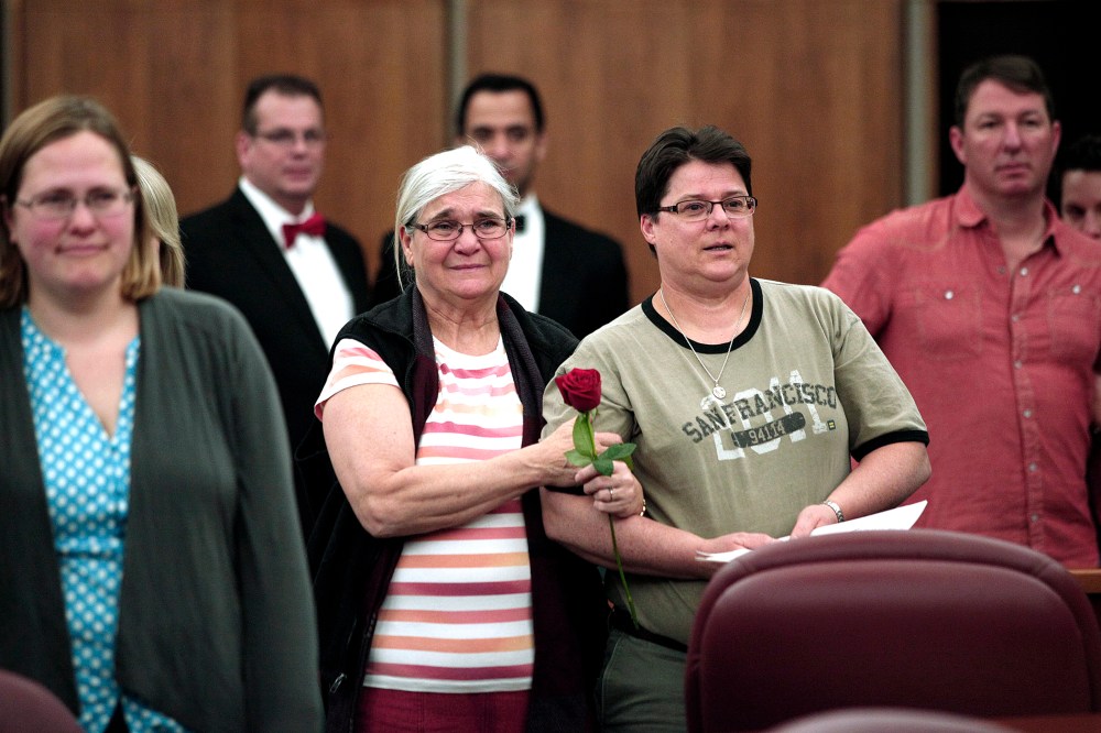 Same-sex couples get married in a group ceremony at the Oakland County Courthouse on March 22, 2014 in Pontiac, Mich.
