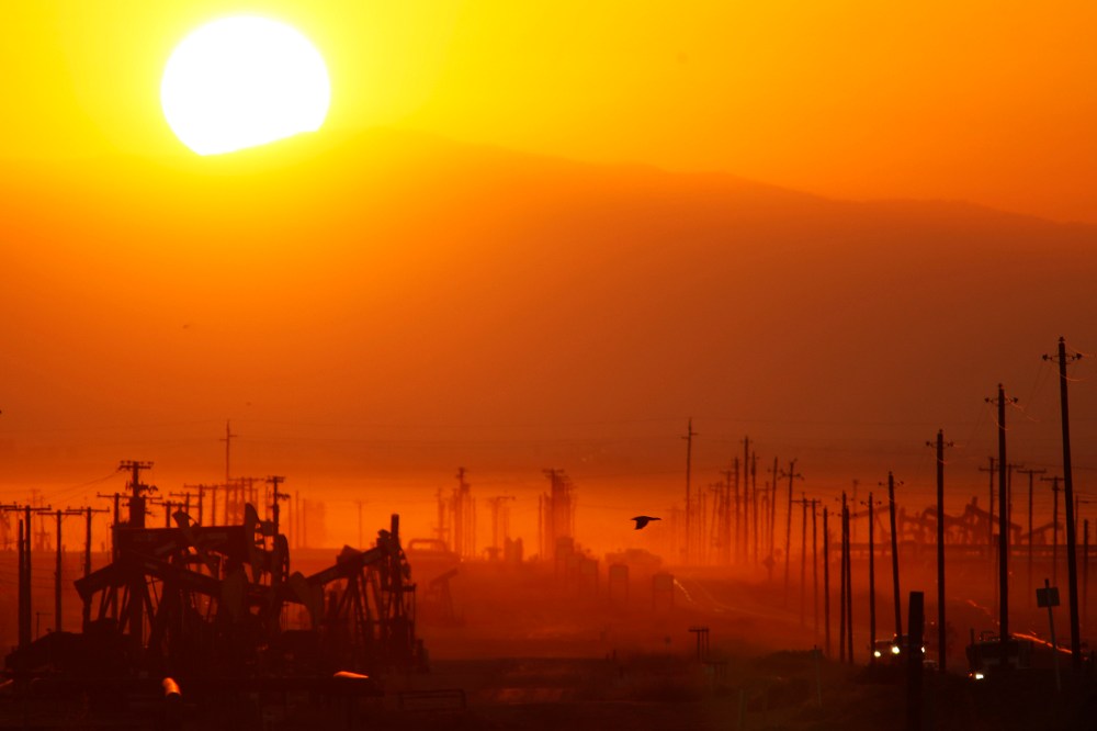 The sun rises over an oil field over the Monterey Shale formation where gas and oil extraction using hydraulic fracturing, or fracking, is on the verge of a boom on March 24, 2014 near Lost Hills, Calif.