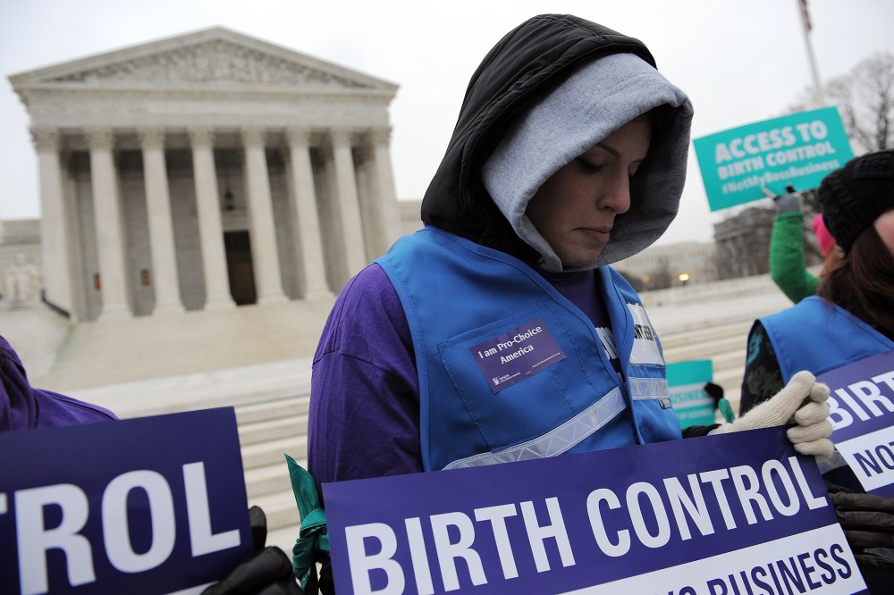 Alena Yarmosky holds a sign outside the Supreme Court of the United States on March 25, 2014 in Washington, DC.