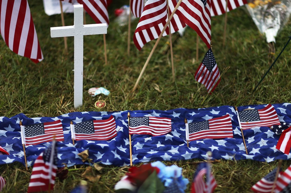 Five American flags in honor of the five killed are seen lain out in the memorial near the Armed Forces Career Center/National Guard Recruitment Office which had been shot up on July 19, 2015 in Chattanooga, Tenn. (Photo by Joe Raedle/Getty)