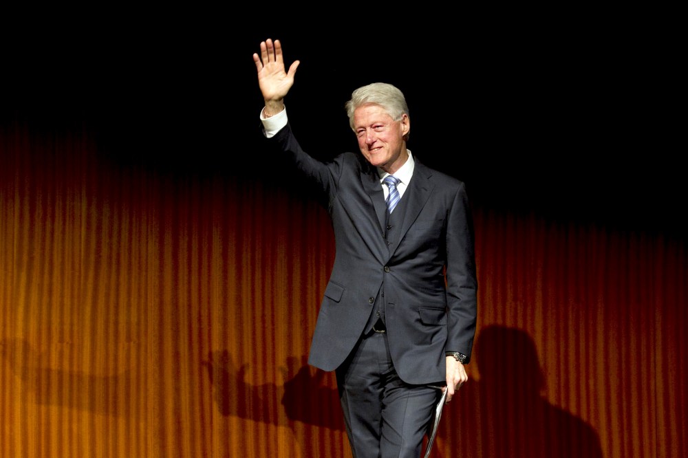 Former President Bill Clinton waves after giving a speech during the Civil Rights Summit at the LBJ Presidential Library, April 9, 2014 in Austin, Texas.