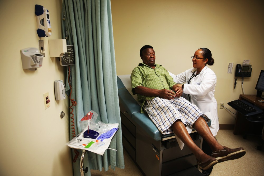 Felue Chang, who is newly insured under an insurance plan through the Affordable Care Act, receives a checkup, April 15, 2014 in Hollywood, Florida.