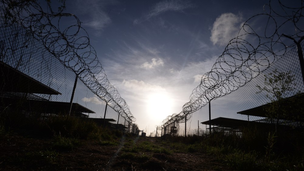 This photo made during an escorted visit and reviewed by the US military, shows the razor wire-topped fence at the abandoned "Camp X-Ray" detention facility at the US Naval Station in Guantanamo Bay, Cuba, April 9, 2014. (Photo Mladen Antonov/AFP/Getty)