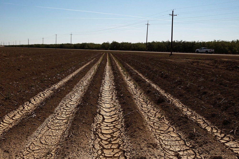 Dried and cracked earth is visible on an unplanted field at a farm on April 29, 2014 near Mendota, California.