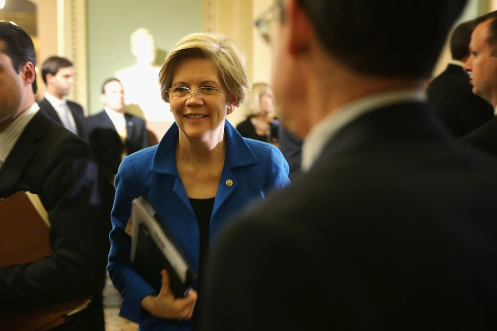 U.S. Sen. Elizabeth Warren (D-MA) (C) walks towards the Senate Chamber after a policy luncheon May 6, 2014 on Capitol Hill in Washington, DC.