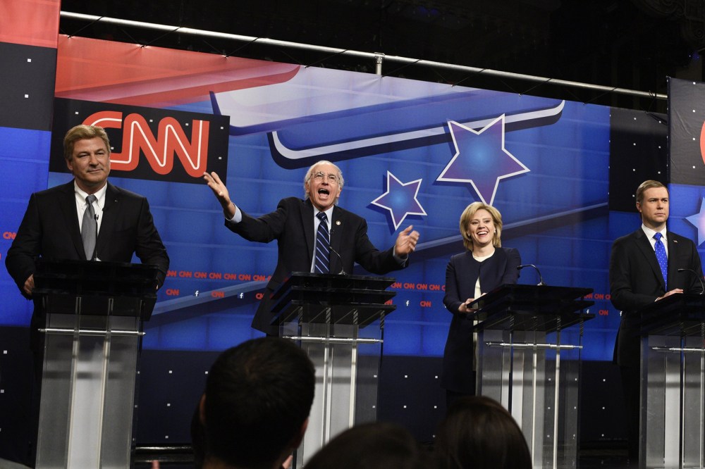 Alec Baldwin as Jim Webb, Larry David as Bernie Sanders, Kate McKinnon as Hillary Clinton, Taran Killam as Martin O'Malley during the "Democratic Debate Cold Open" sketch on Oct. 17, 2015. (Photo by Dana Edelson/NBC/NBCU Photo Bank/Getty)