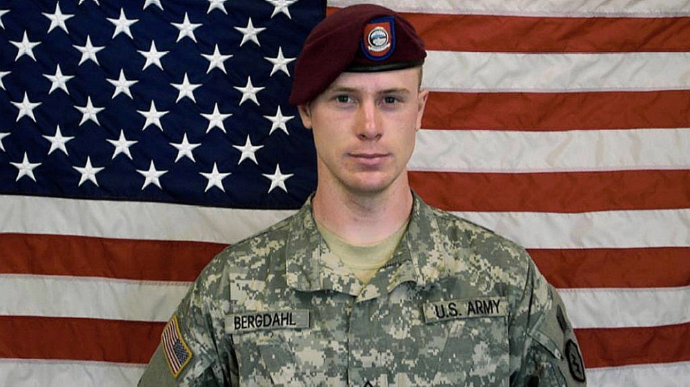 In this undated image provided by the U.S. Army, Sgt. Bowe Bergdahl poses in front of an American flag. (Photo by U.S. Army/Getty)