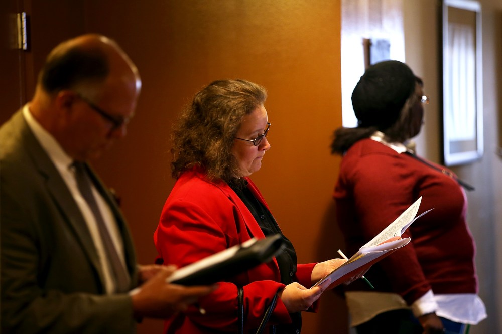 Job seekers fill out applications before the start of the HireLive career fair on June 4, 2014 in San Francisco, California.