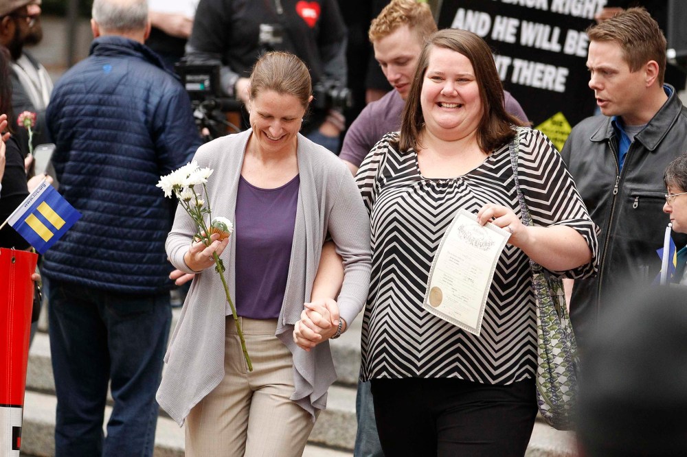 A couple displaying their marriage license reacts after receiving flowers as they leave Jefferson County Courthouse in Birmingham, Ala. in this file photo taken on Feb. 9, 2015.