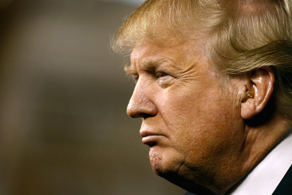 Republican presidential candidate Donald Trump peers out into the crowd during a campaign event at the International Air Response facility on Dec. 16, 2015 in Mesa, Ariz. (Photo by Ralph Freso/Getty)