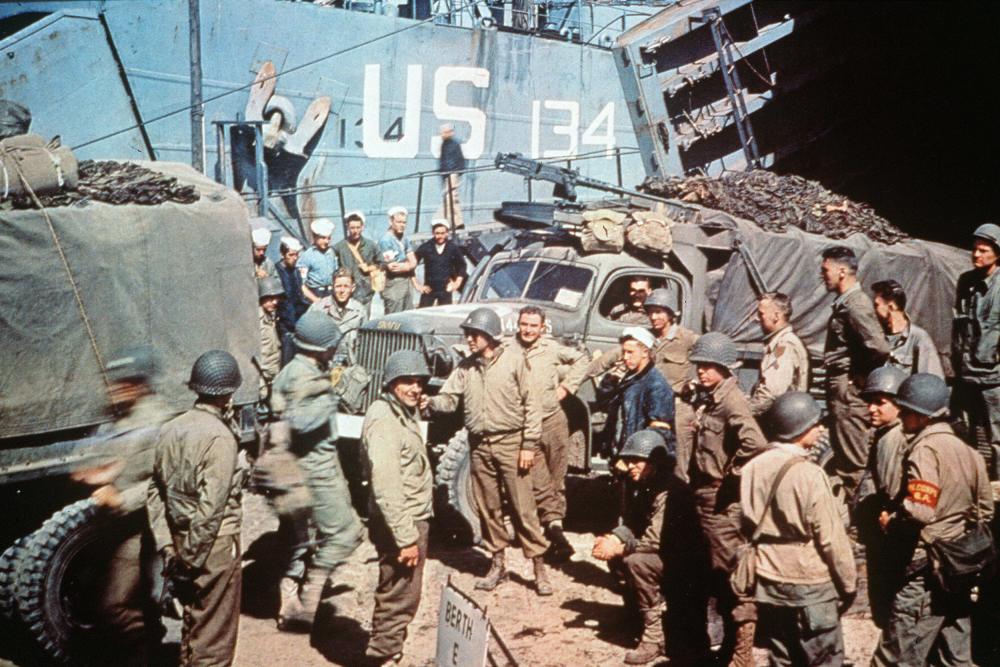 US soldiers gather around trucks disembarking from landing crafts shortly after Allied forces stormed the Normandy beaches, June 6, 1944.