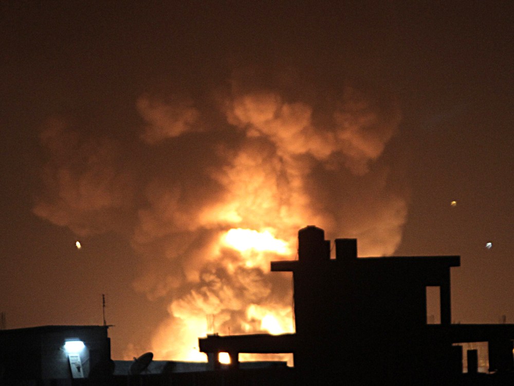 Fire rises during an explosion following an Israeli strike on the border tunnels between Egypt and Rafah in the southern Gaza Strip on November 20, 2012. US Secretary of State Hillary Clinton vowed to support Israeli security on November 20  while...