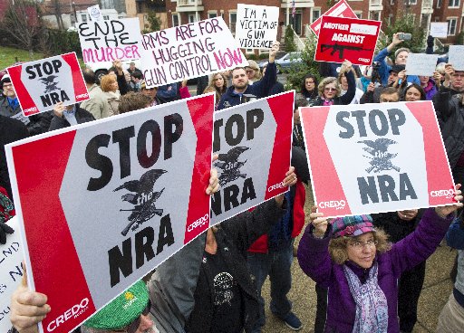 Protesters march against the National Rifle Association's Capitol Hill office demanding the pro-gun lobby stand down in reaction to the shooting at Sandy Hook Elementary School. (AFP Photo/Paul J. Richards PAUL J. RICHARDS/AFP/Getty Images)