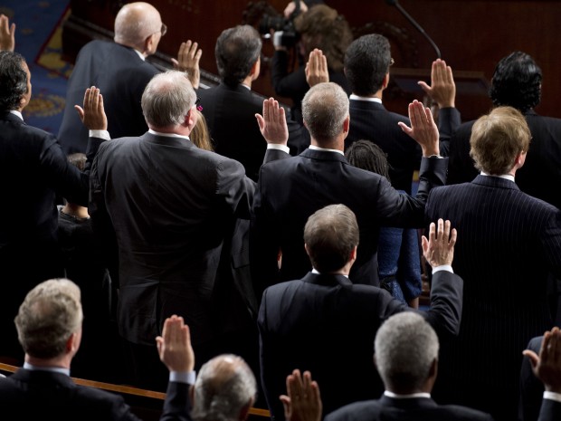 Members of the 113th US House of Representatives take their oath as they are sworn in during the opening session at the US Capitol in Washington, DC, on January 3, 2013. (Photo by Saul Loeb/AFP/Getty Images)