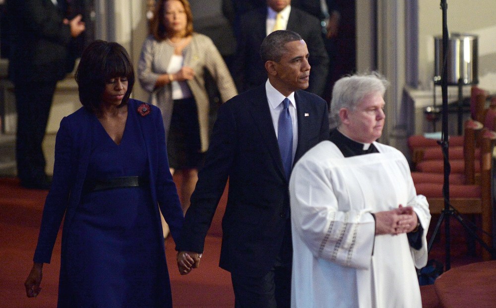 President Barack Obama and first lady Michelle Obama arrive at the "Healing Our City: An Interfaith Service" dedicated to those who were gravely wounded or killed in the Boston Marathon bombing, at the Cathedral of the Holy Cross in Boston,...