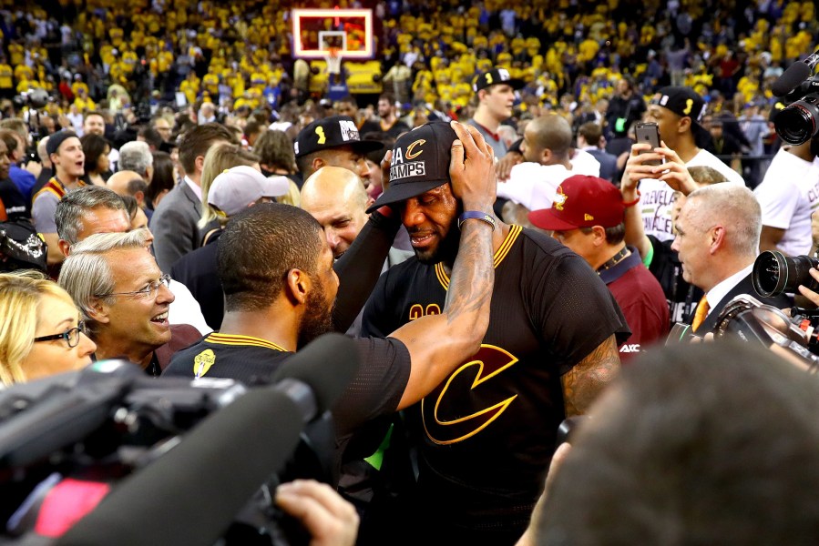 LeBron James #23 and Kyrie Irving #2 of the Cleveland Cavaliers celebrate after defeating the Golden State Warriors 93-89 in Game 7 of the 2016 NBA Finals at ORACLE Arena on June 19, 2016 in Oakland, Calif. (Photo by Ezra Shaw/Getty)