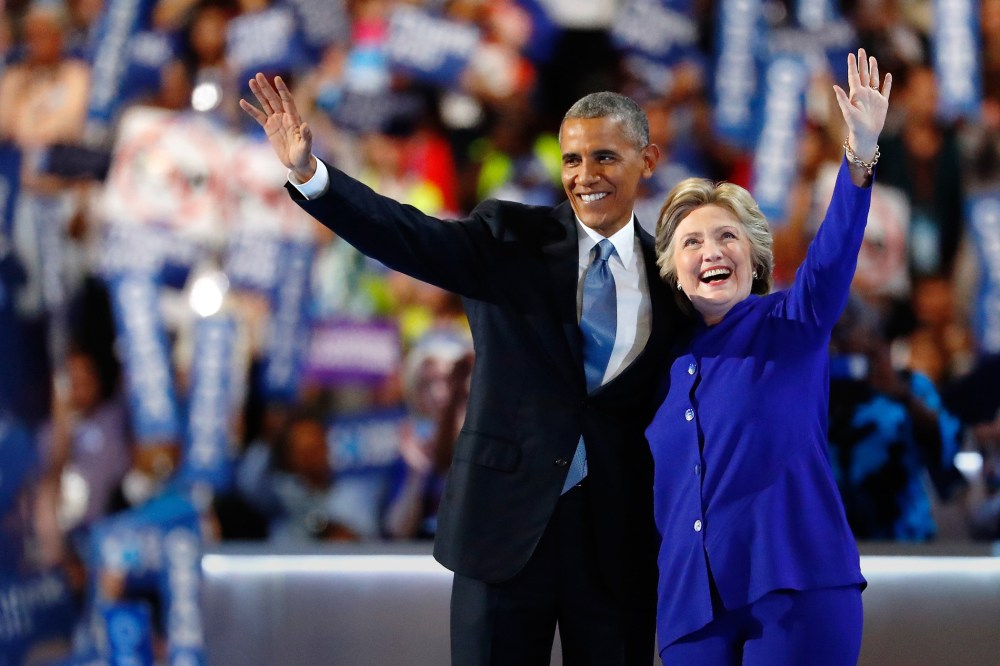 President Barack Obama and Democratic presidential candidate Hillary Clinton wave to the crowd at the Democratic National Convention, July 27, 2016 in Philadelphia, Penn. (Photo by Aaron P. Bernstein/Getty)