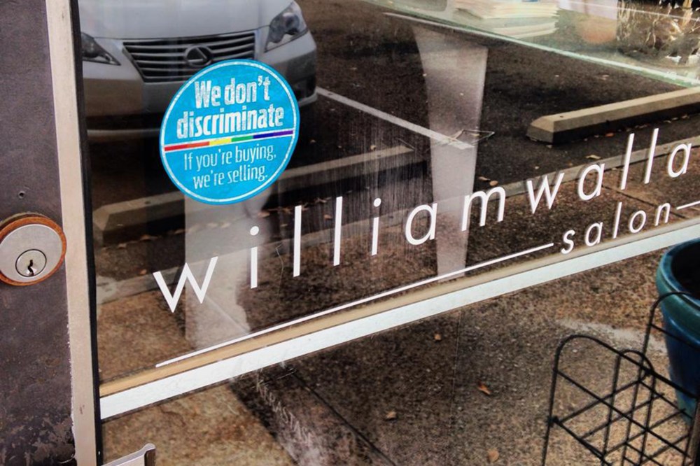A sticker outside the Williams Wallace Salon in Jackson, Miss. promoting the "If You're Buying, We're Selling" campaign