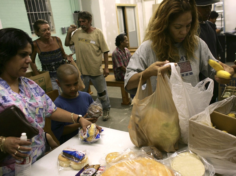 Families gather food at a food pantry for those in need inside the Streets of Destiny Church in Phoenix, Arizona.