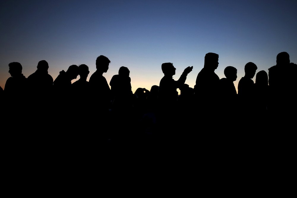 Migrants and refugees queue for food at a makeshift camp at the Greek-Macedonian border near the village of Idomeni, Greece, March 30, 2016. (Photo by Marko Djurica/Reuters)