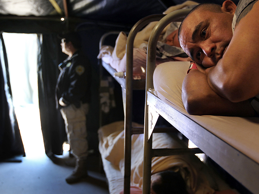 Undocumented Mexican immigrant Gabriel Lopez, 34, lies on his bunk bed at the Maricopa County "Tent City Jail" on April 30, 2010 in Phoenix, Arizona. (Photo by John Moore/Getty Images)
