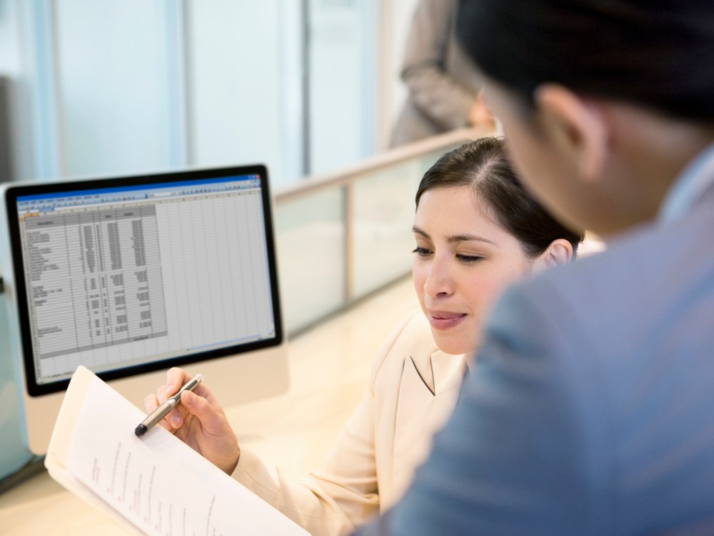 Businesswoman reviewing co-worker. (Stock Photo by Robert Nicholas/OJO Images/Getty Images)
