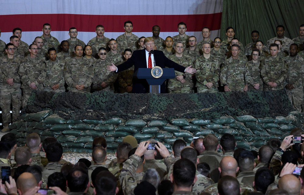 In this file photo taken on November 28, 2019 US President Donald Trump speaks to the troops during a surprise Thanksgiving day visit at Bagram Air Field, in Afghanistan.