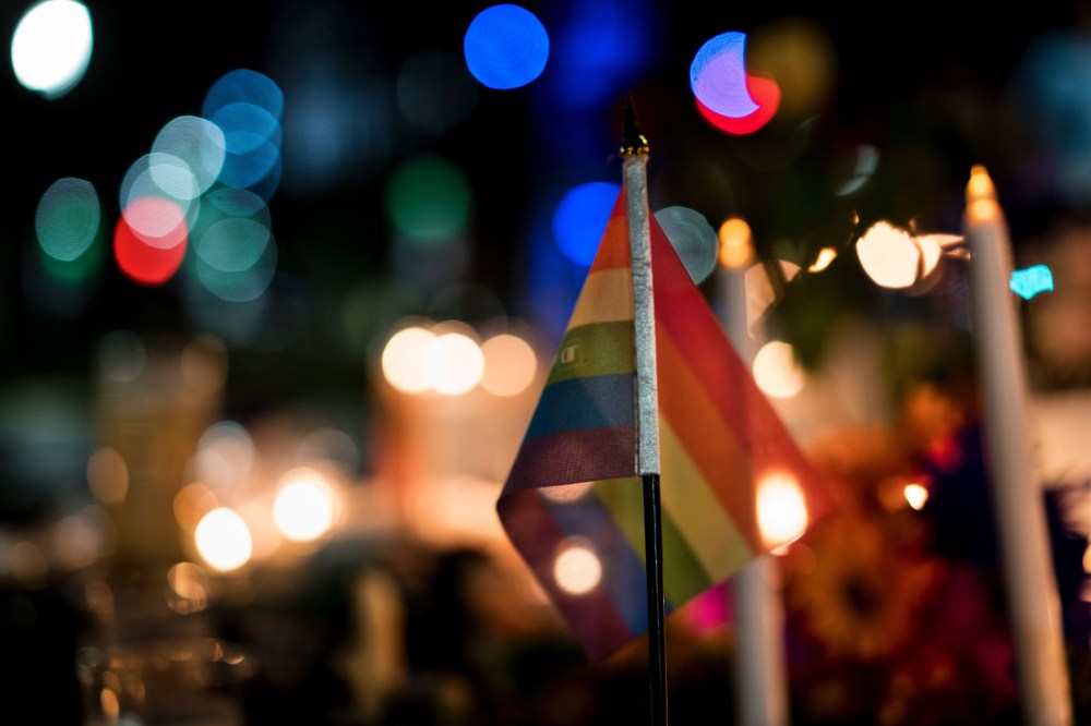 A gay pride flag is seen at a memorial after a vigil outside the Dr. Phillips Center for the Performing Arts for the mass shooting victims at the Pulse nightclub June 13, 2016 in Orlando, Fla. (Photo by Brendan Smialowski/AFP/Getty)